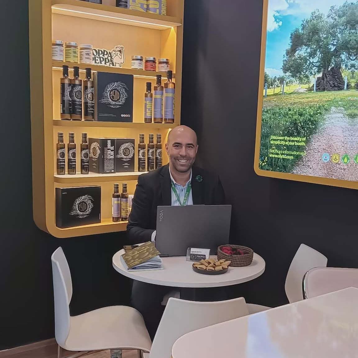 Ahmed working alone at his stand at a trade show