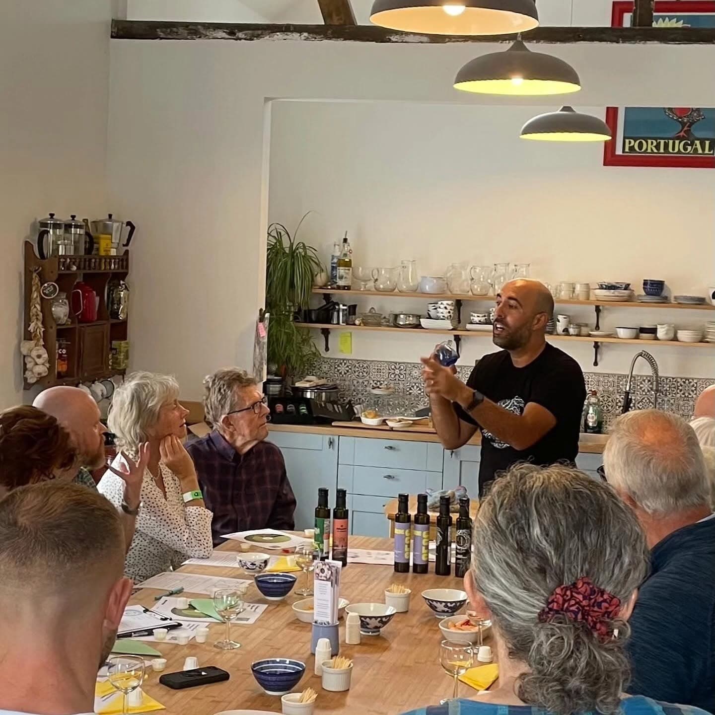 Ahmed leading an olive oil tasting for a room of guests